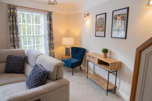 a living room with a couch and a table and a chair at Number Six in Ironbridge