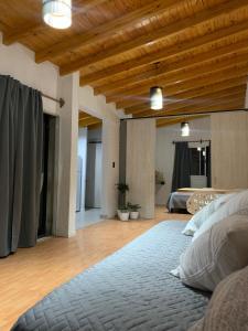 a bedroom with a bed and a wooden ceiling at Departamento vista de montaña in Las Heras