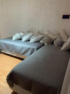 a bedroom with two beds with pillows on them at Departamento vista de montaña in Las Heras