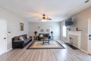 a living room with a couch and a ceiling fan at Charming Suburb 20 Min to ATL! in Decatur