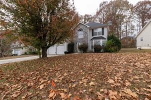 a yard full of leaves in front of a house at Charming Suburb 20 Min to ATL! in Decatur