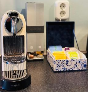 a blender sitting on a counter next to a box of food at Décor Canal House in Amsterdam