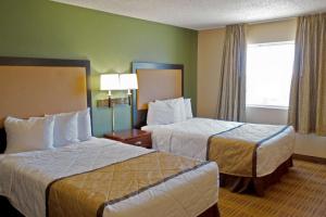 a hotel room with two beds and a window at Extended Stay America Suites - Dallas - Richardson in Richardson