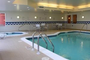 a large pool with chairs and a table in a hotel at Fairfield Inn and Suites by Marriott Marion in Marion
