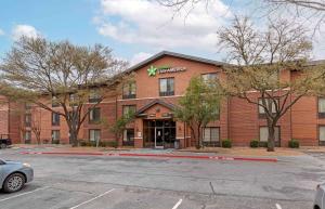 a building with a parking lot in front of it at Extended Stay America Suites - Austin - Metro in Austin