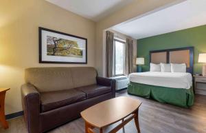 a hotel room with a bed and a couch at Extended Stay America Suites - Austin - Metro in Austin