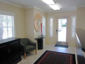 a living room with a chair and a mirror at Extended Stay America Suites - San Antonio - Airport in San Antonio