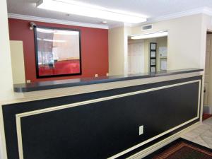 a lobby with a black and gold reception counter at Extended Stay America Suites - San Antonio - Airport in San Antonio
