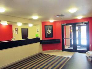 a bathroom with red walls and a large mirror at Extended Stay America Suites - Austin - Northwest - Lakeline Mall in Austin