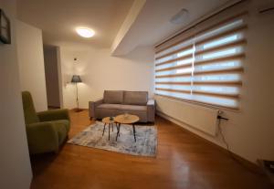 a living room with a couch and a table at Modern Living Apartments in Skopje