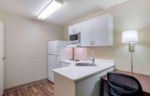 a small kitchen with a sink and a refrigerator at Extended Stay America Suites - Huntsville - US Space and Rocket Center in Huntsville