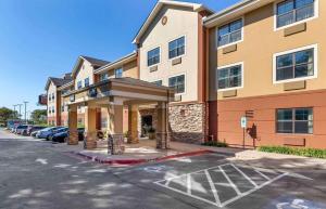 a hotel building with a parking lot in front of it at Extended Stay America Select Suites - Fayetteville - Springdale in Springdale