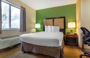a hotel room with a large bed and a window at Studio 6 Suites Jackson Ridgeland MS in Ridgeland