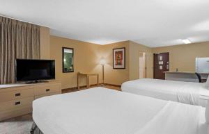 a hotel room with two beds and a flat screen tv at Extended Stay America Suites - Houston - Med Ctr - Greenway Plaza in Houston