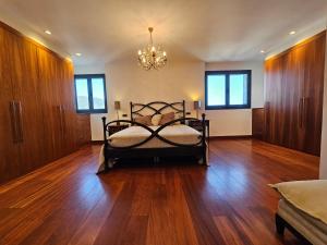 a bedroom with a bed and a chandelier at Mirador La Jirafa - 638A in Oviedo