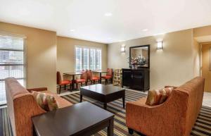 a waiting room with couches and tables and chairs at Extended Stay America Suites - Seattle - Bothell - Canyon Park in Bothell