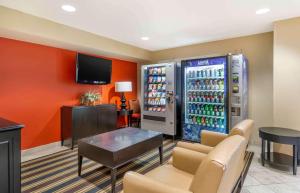 a room with a soda vending machine with a table and chairs at Extended Stay America Suites - Seattle - Bothell - Canyon Park in Bothell