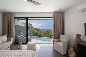 a living room with a view of a pool at Adults Only! Ocaso Luxury Villas Entire Property in Rincon