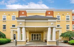 a large yellow building with white columns at Extended Stay America Suites - Seattle - Everett - Silverlake in Murphys Corner