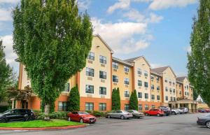 a large apartment building with cars parked in a parking lot at Extended Stay America Suites - Seattle - Kent in Kent