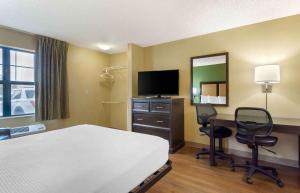 a hotel room with a bed and a desk with two chairs at Extended Stay America Suites - Seattle - Kent in Kent