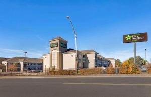 a building on the side of a road with a sign at Extended Stay America Select Suites - Denver - Cherry Creek in Denver