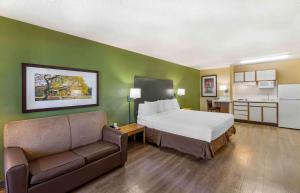 a hotel room with a bed and a couch at Extended Stay America Select Suites - Denver - Cherry Creek in Denver
