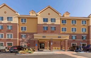 a large building with cars parked in a parking lot at Extended Stay America Suites - Denver - Park Meadows in Lone Tree