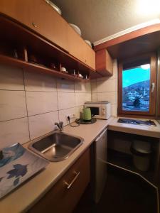 a small kitchen with a sink and a microwave at Apartments Emily in Sarajevo