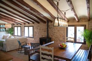 a living room with a wooden dining room table at La Masia Alt Penedès in Pontons