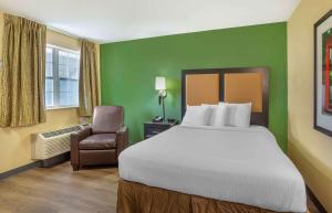 a hotel room with a bed and a chair at Extended Stay America Suites - Nashville - Brentwood - South in Brentwood