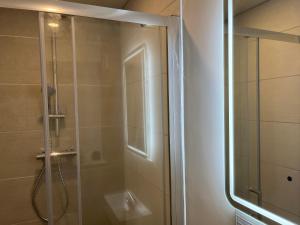 a shower with a glass door in a bathroom at Green haven in Winford