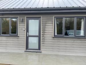 a house with three windows and a door at Green haven in Winford