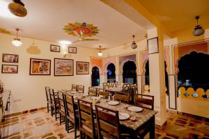 a dining room with a long table and chairs at Rajputana Heritage in Sawāi Mādhopur