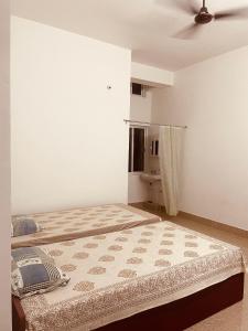 a bedroom with a bed and a ceiling fan at Comfort Family Homestay in Guwahati