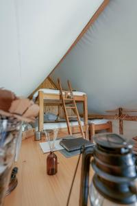 a room with a table and chairs in a attic at Altipik - Lodges Insolites in Mont-Saxonnex