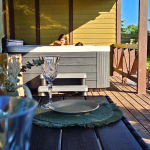 a table with a plate of food on a deck at Resort Baure in Palanga