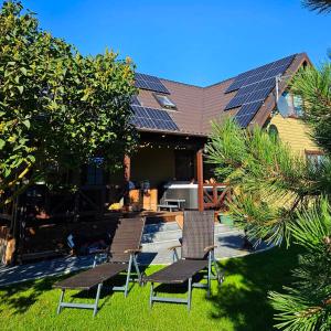 a house with solar panels on the roof at Resort Baure in Palanga