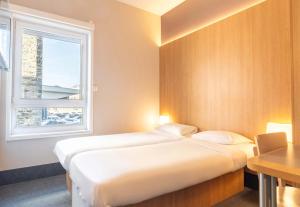 Postel nebo postele na pokoji v ubytování B&B HOTEL Limoges Centre Gare