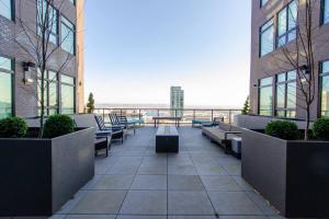 a balcony with benches and a view of the ocean at 2 - Private Balconies2- King Bedsworkspacegym in Tacoma