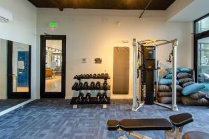 a gym with a bunch of equipment in a room at 2 - Private Balconies2- King Bedsworkspacegym in Tacoma
