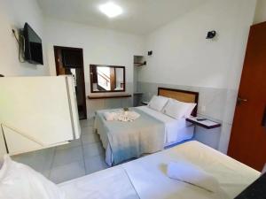 Postel nebo postele na pokoji v ubytování Pousada Camburi Star