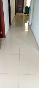 a hallway with white tiled floors and doors at Casa Elegante, Cómoda y Relax in Santa Cruz de la Sierra