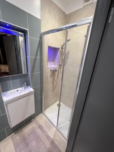a bathroom with a shower and a sink at Rooms in Modernised Victorian House in Croydon