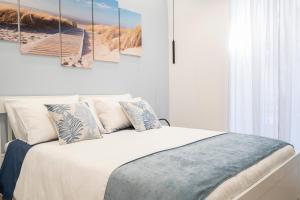 a bedroom with a bed and a painting on the wall at Dolci Coccole Small Suite a Bari città! in Bari