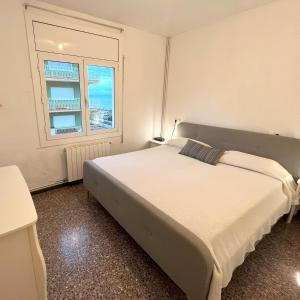 ピネダ・デ・マールにあるApartamento frente del marの窓のある大きな白いベッドのある寝室
