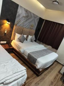 ein Hotelzimmer mit einem Bett und einer Wand in der Unterkunft HOTEL RJ RESIDENCY in Ahmedabad