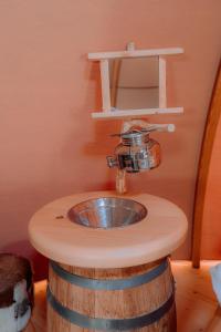 a bathroom with a sink on top of a barrel at Altipik - Lodges Insolites in Mont-Saxonnex