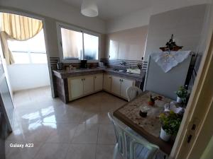 a kitchen with a sink and a refrigerator at Big Appartement with 3 bedrooms in Sale