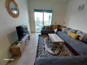 a living room with a blue couch and a table at Big Appartement with 3 bedrooms in Sale